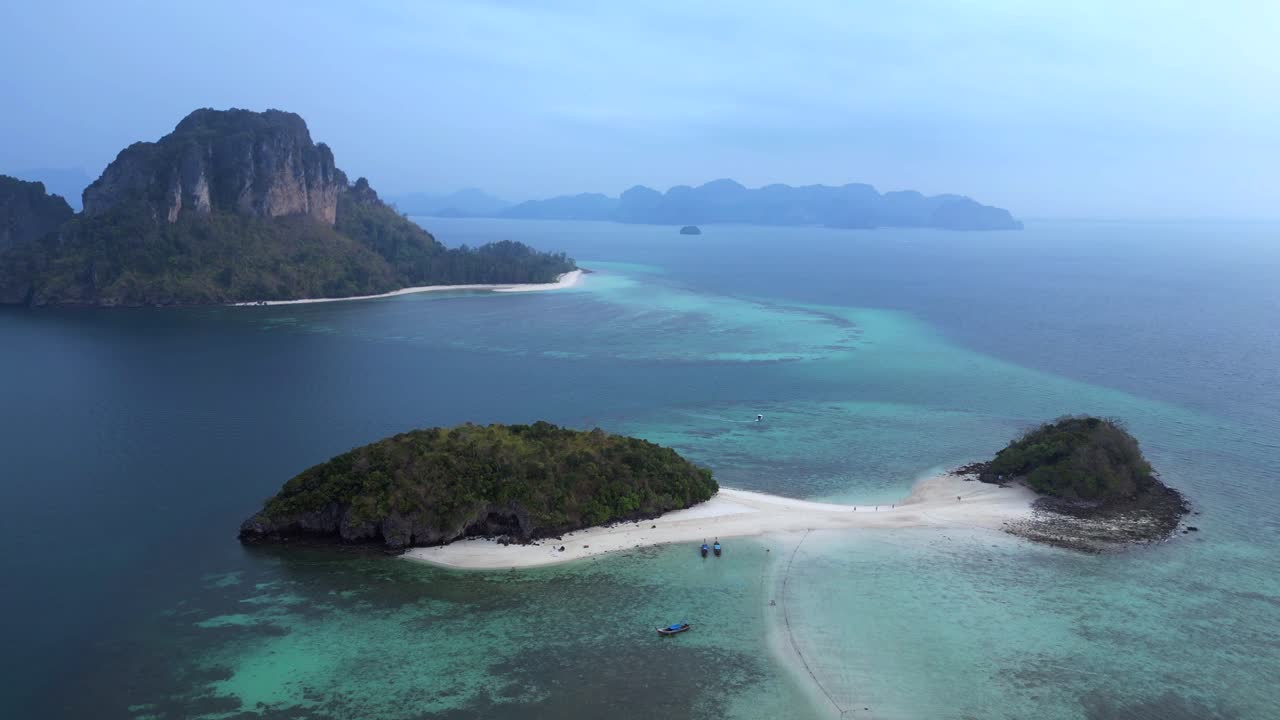 couple lonely on a sandbank Ko Kai island Krabi, Thailand. Spectacular aerial view flight speed ramp hyper motion time lapse