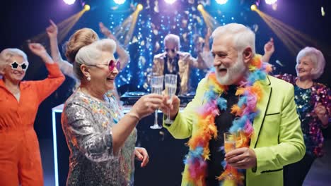 group of stylish senior people dancing and toasting with champagne flutes at a disco party, having fun together