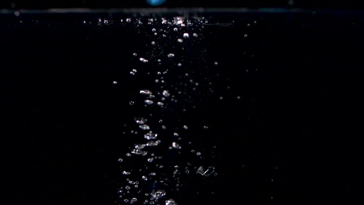 Abstract Stones Falling into Water in Slow Motion with Lots of Bubbles
