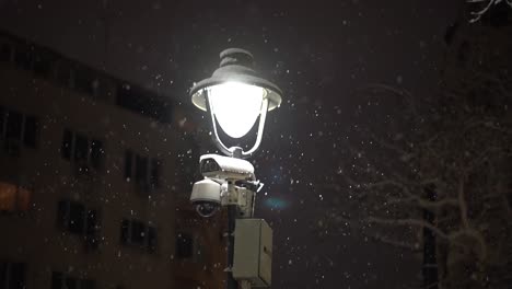 Camera-surveillance-while-snowing-in-slow-motion-in-a-city