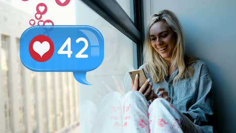 woman sitting on a window sill typing on her phone 4k