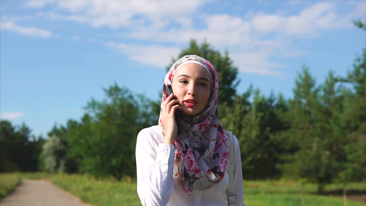 Muslim Woman Talking on Phone Outdoors