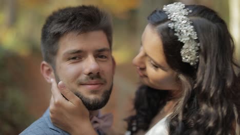 groom with bride near mountain hills in the forest. couple. making a kiss