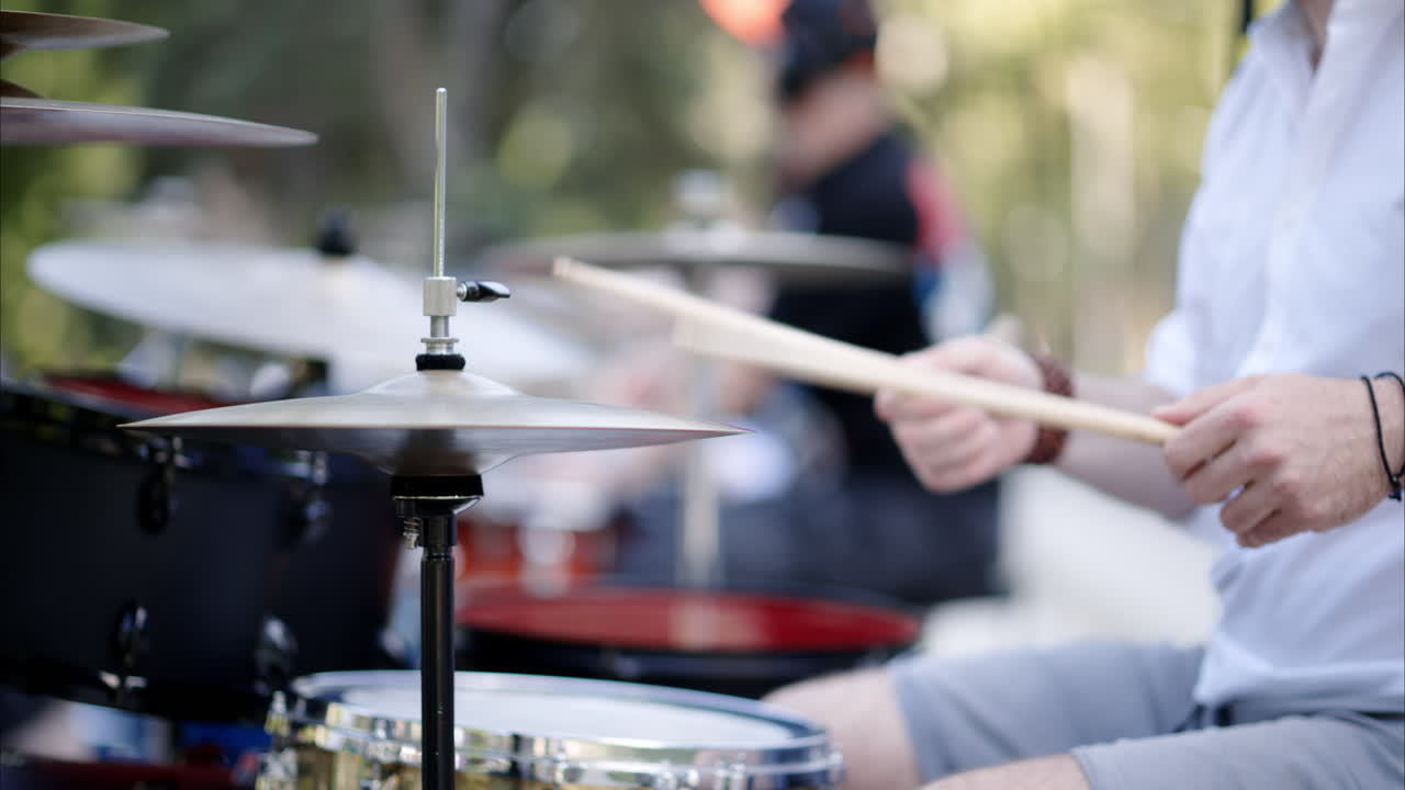 Close up of man playing the drums outside