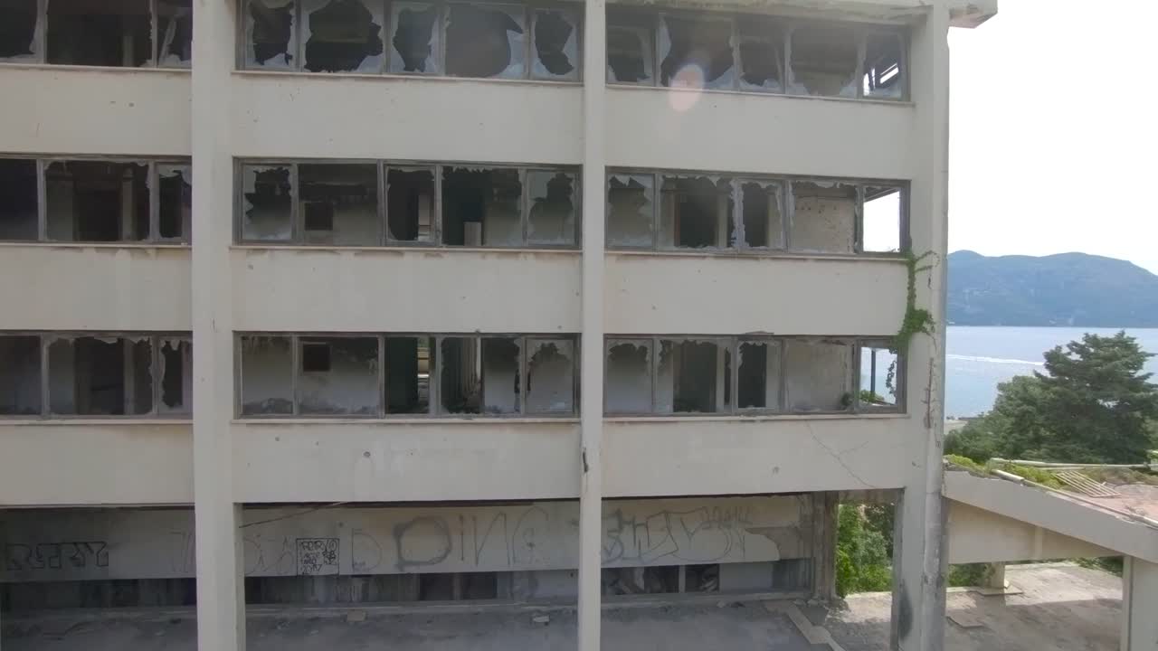 Aerial Drone Footage of a Man Walking Through a Abandon Hotels on Kupari Beach, Croatia.