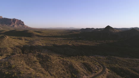 AERIAL---Desert-Mountain-Road-During-Golden-Hour