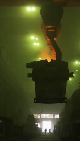 steel mill interior with crane and workers