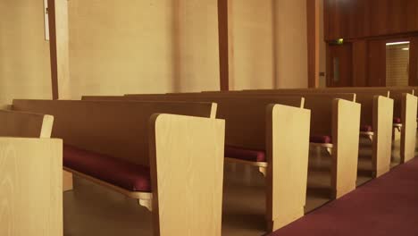 wide dolly shot of empty pews in a historical church building