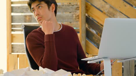 male executive sitting at desk and looking away 4k