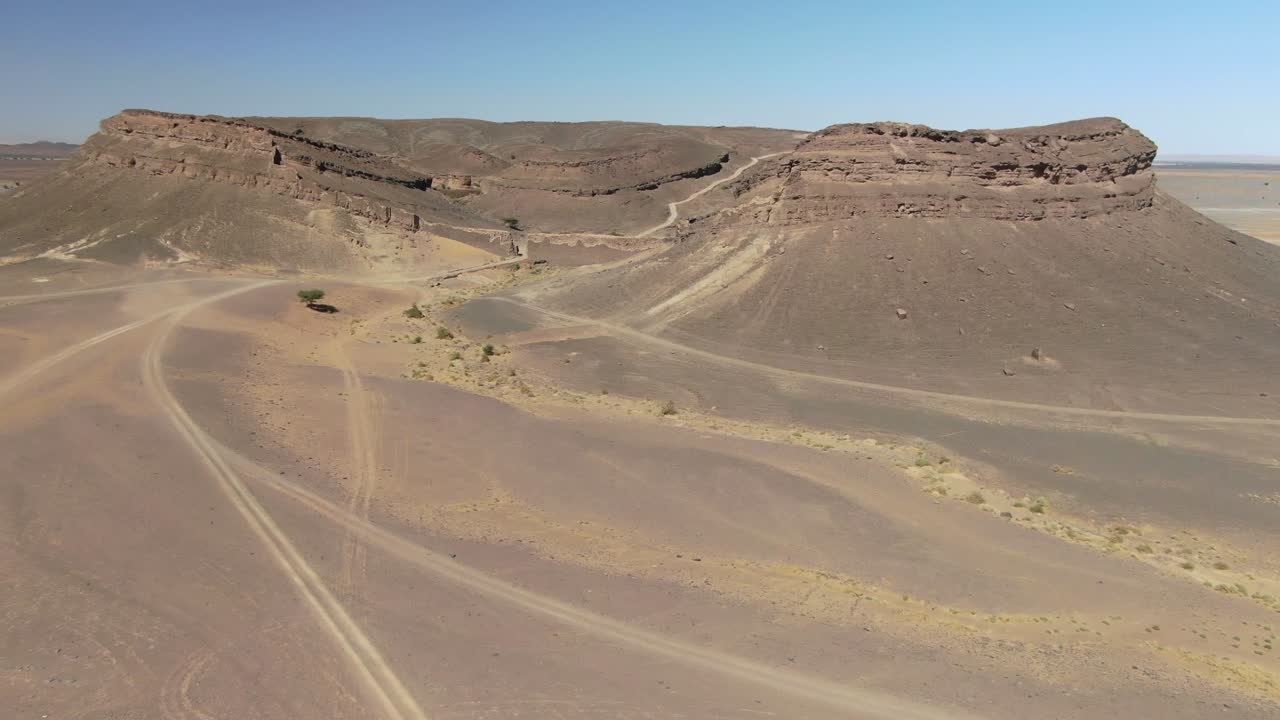 Beautiful unusual Gara Medouar horseshoe shaped rock formation in Morocco. Aerial drone approach