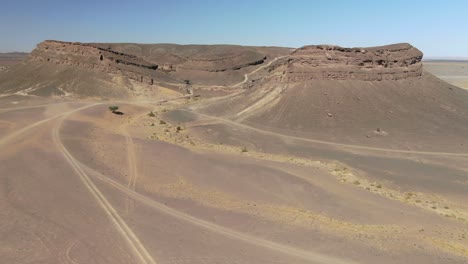 beautiful unusual gara medouar horseshoe shaped rock formation in morocco. aerial drone approach