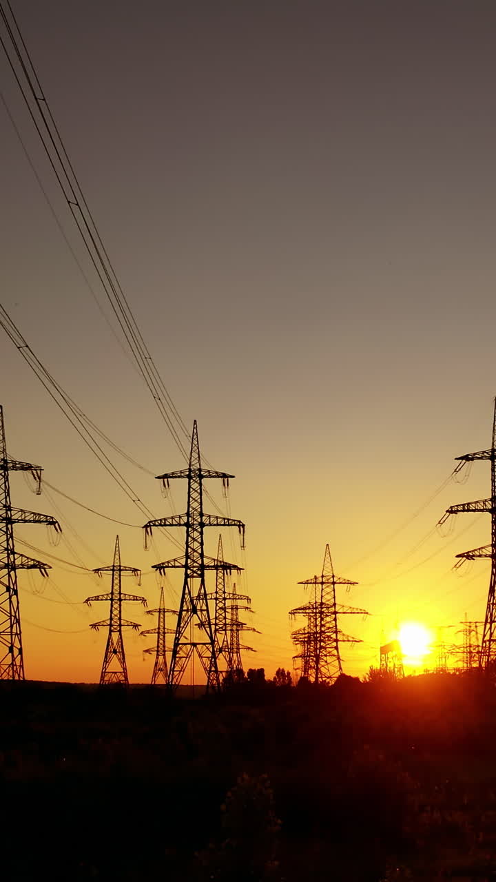 High voltage towers. High voltage power lines during sunset