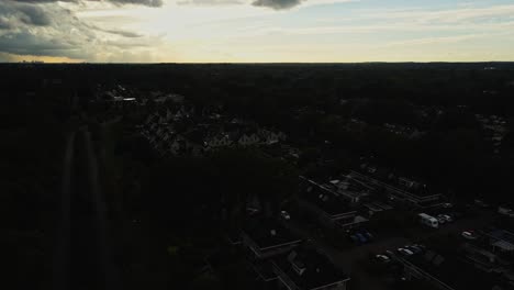beautiful aerial of a rural suburban neighborhood with a gorgeous sunset in the background