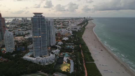 aerial drone fly above miami south beach, sea coast resorts and dayline skyline, united states of america travel destination