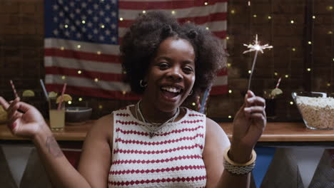 Woman Celebrating with Sparkler at a Patriotic Party