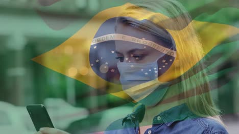 Animation-of-flag-of-brazil-waving-over-woman-in-face-masks