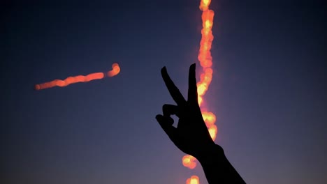 peace sign against fireworks