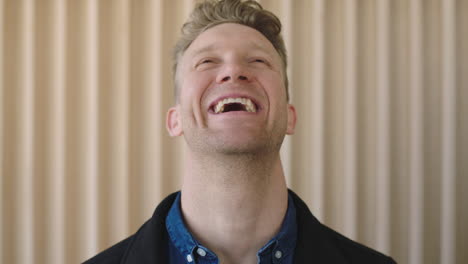 close-up-portrait-of-attractive-caucasian-man-looking-confident-at-camera-laughing-cheerful-positive