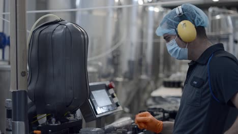 brewery worker operating automation machinery