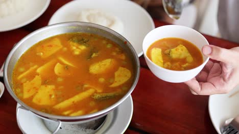 delicious yellow curry being served in bowls