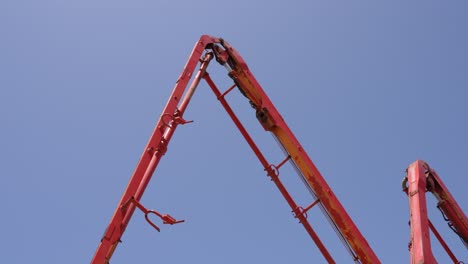 view of a concrete pump moving against a clear blue sky