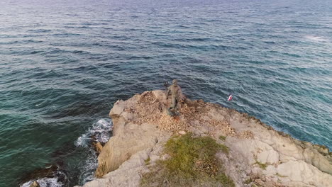 Aerial-orbiting-over-symbolic-Neptune-Statue,-Dominican-Republic