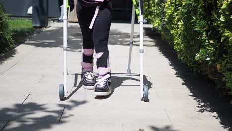 child with leg brace using walking frame