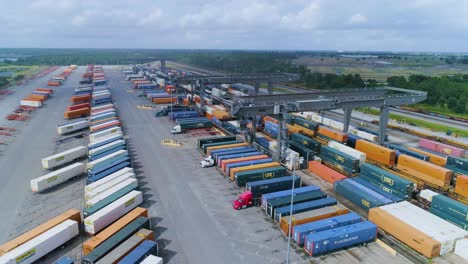 4k drone video of trains and trucks at csx intermodal train yard in winter haven, fl