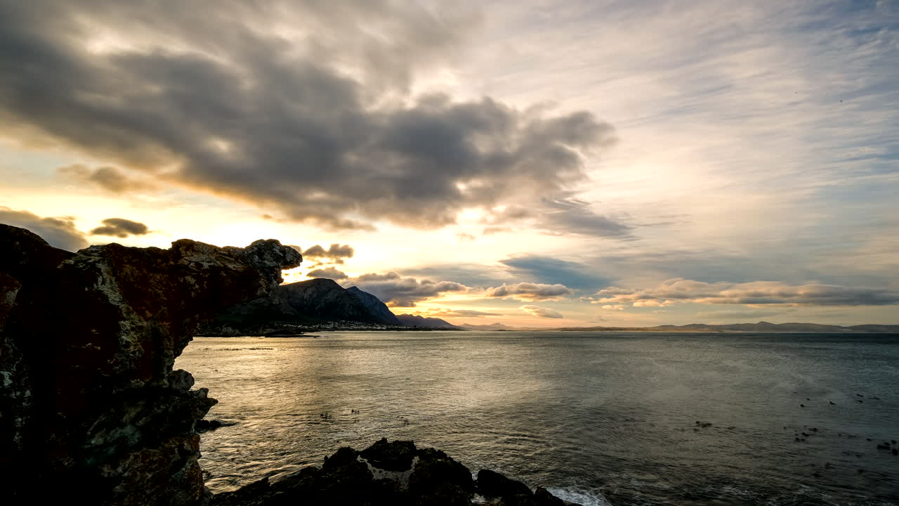 Scenic sunrise time-lapse with cloud movement over Walker Bay in Hermanus