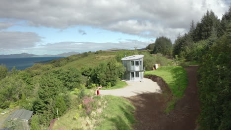 AERIAL---establishing-shot-of-a-quirky-aluminum-house-in-Scotland