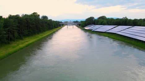 Captivating-aerial-4K-drone-footage-of-a-solar-panel-plant-nestled-alongside-the-Drava-river-in-Slovenia