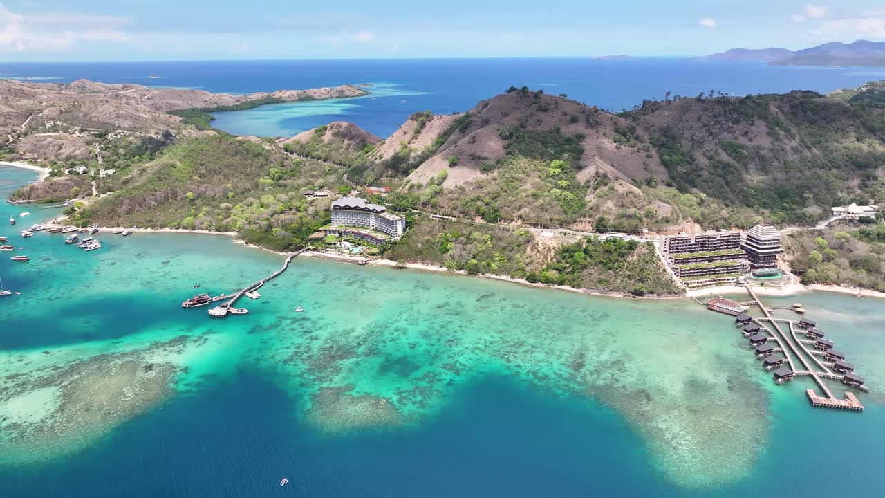 Amazing coastal of Flores, with hotels and picturesque landscape. Indonesia drone.