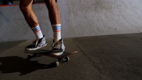 man practicing skateboarding in skateboard arena 4k