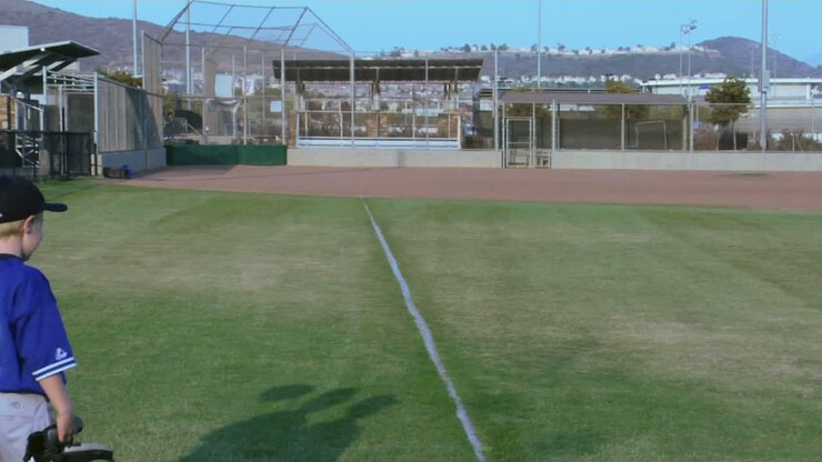 Little league baseball players place their arms around one another as they walk