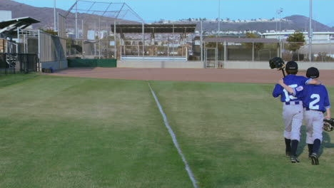 Little-league-baseball-players-place-their-arms-around-one-another-as-they-walk