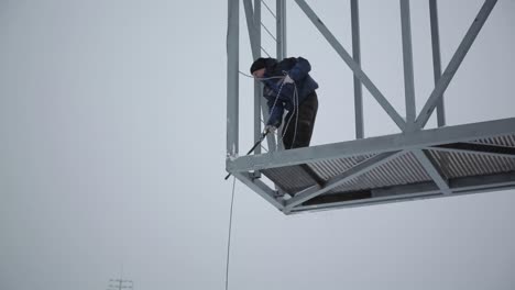 worker on a metal structure platform in winter