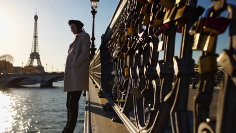 woman on bridge with eiffel tower in background