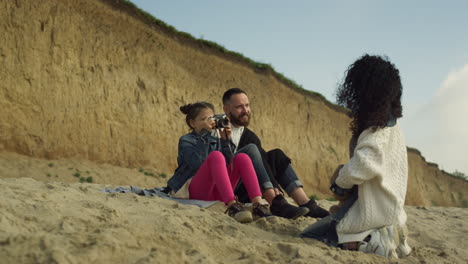 calm family spend time together on sea beach. happy people taking photos outside