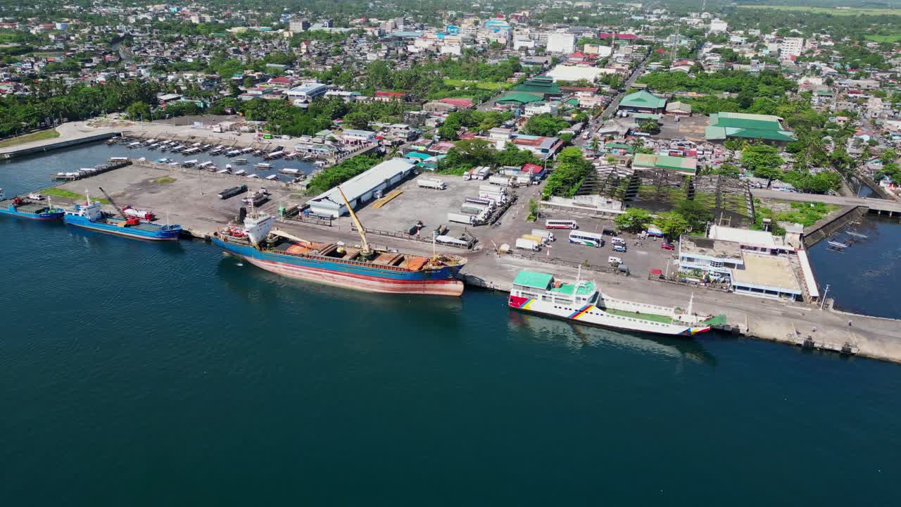 Cargo Ships And Passenger Ferry Docked At Port Of Tabaco In Tabaco City, Albay, Philippines. aerial shot