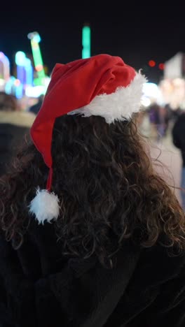 person wearing a santa hat at a festive holiday event