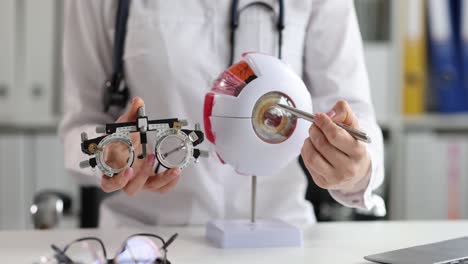 optometrist explaining eye examination tools and anatomy