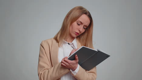 thoughtful journalist business woman making notes, writing down thoughts notebook diary, to do list