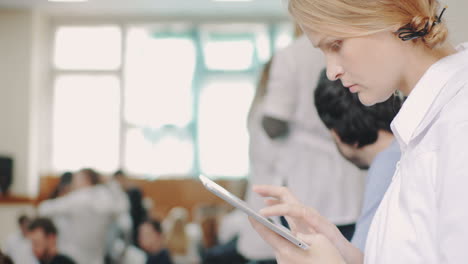 Young-medical-student-using-pad-during-break