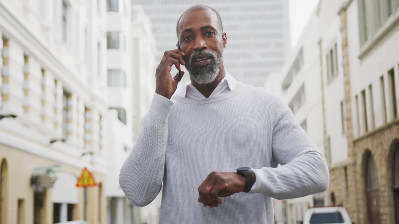 African American man using his phone in the street