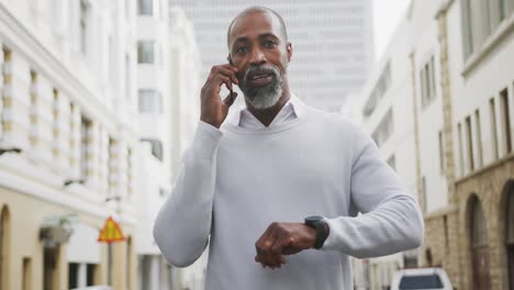 african american man using his phone in the street