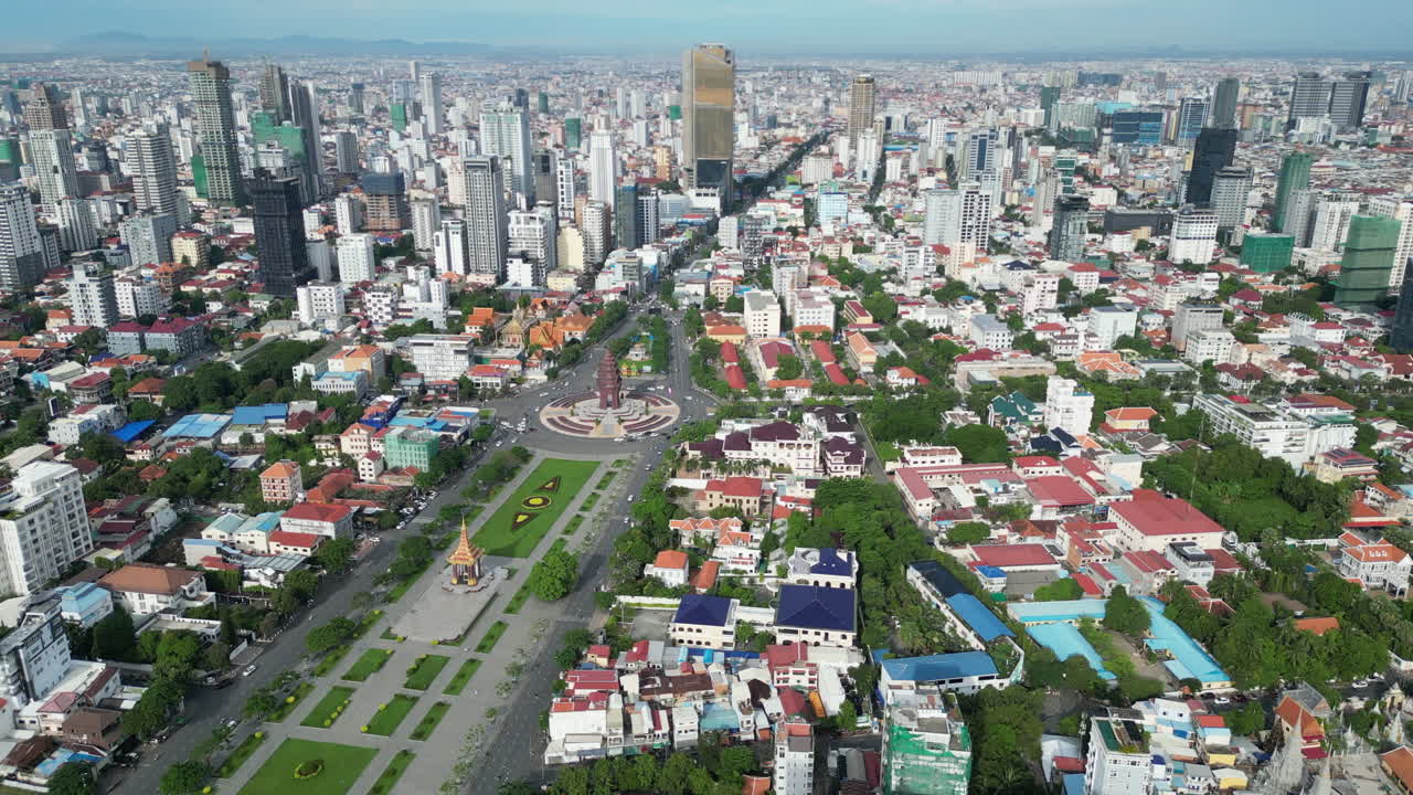 Aerial video of Phnom Penh highlights Independence Monument at the center of a grand boulevard, with the city’s dense high-rises and skyline rising behind it