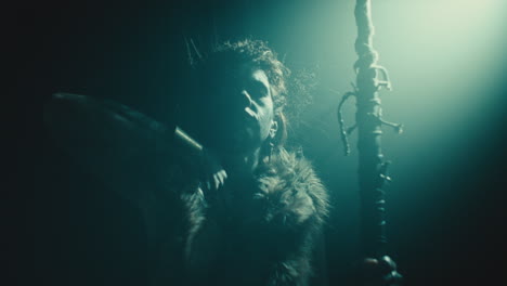 the witch makes a gesture of cutting her throat