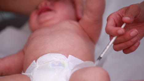 Mother-and-female-doctor-doing-an-injection-on-a-baby