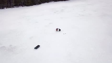 Get-an-aerial-view-of-Ice-Fishing-on-Fitzgerald-Pond,-Maine