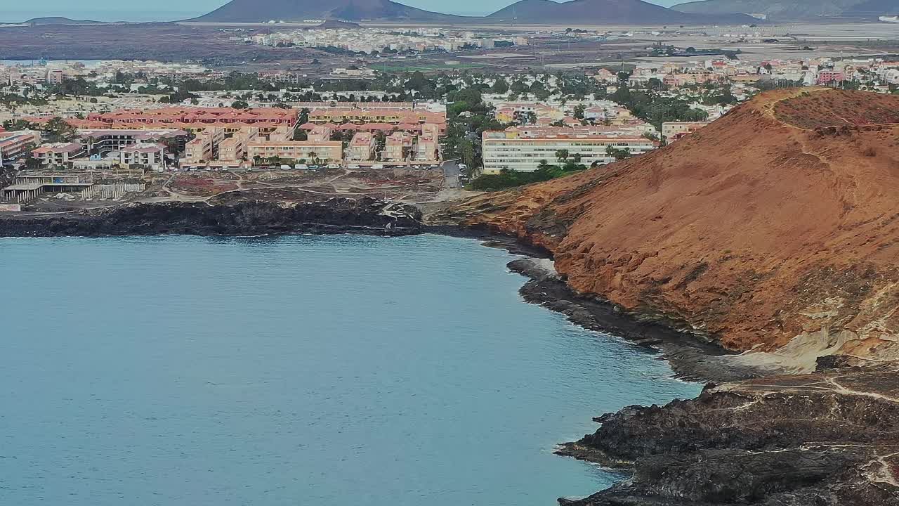 View of Tenerife coast with cliffs and buildings near the water